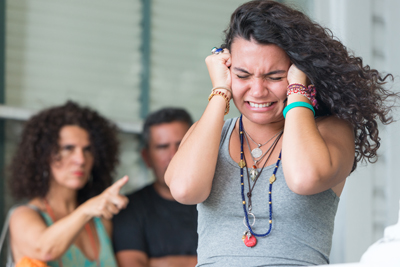 Very upset parents scolding their daughter